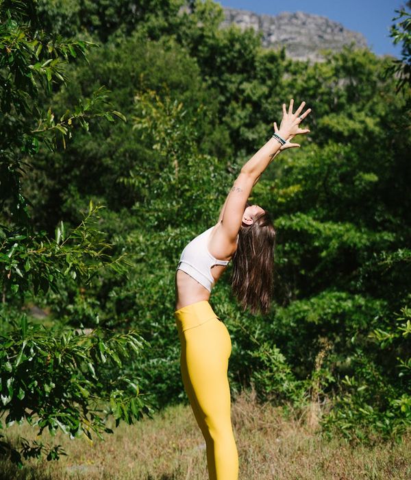 Woman in a balanced tree yoga pose outdoors, feeling centered.